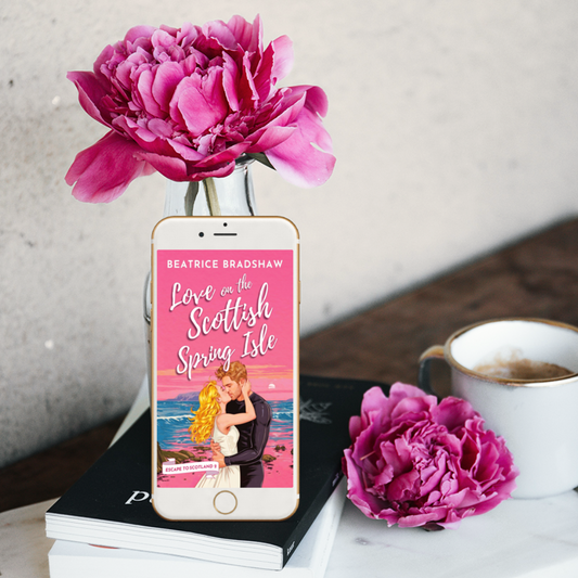 Love on the Scottish Spring Isle on an iPhone Screen in a setting with coffee and pink flowers