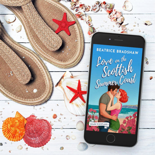The Cover of Love on the Scottish Summer Coast on an iPhone Screen surrounded by starfish and sea shells next to a pair of woven sandals - very summery.