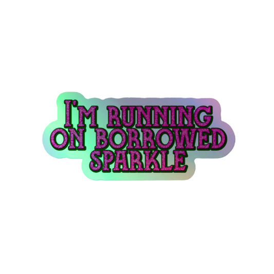 A die-cut sticker with the text 'I'M RUNNING ON BORROWED SPARKLE' in stylized purple letters with a black outline, set against a mint green and lavender gradient background on a plain white backdrop.