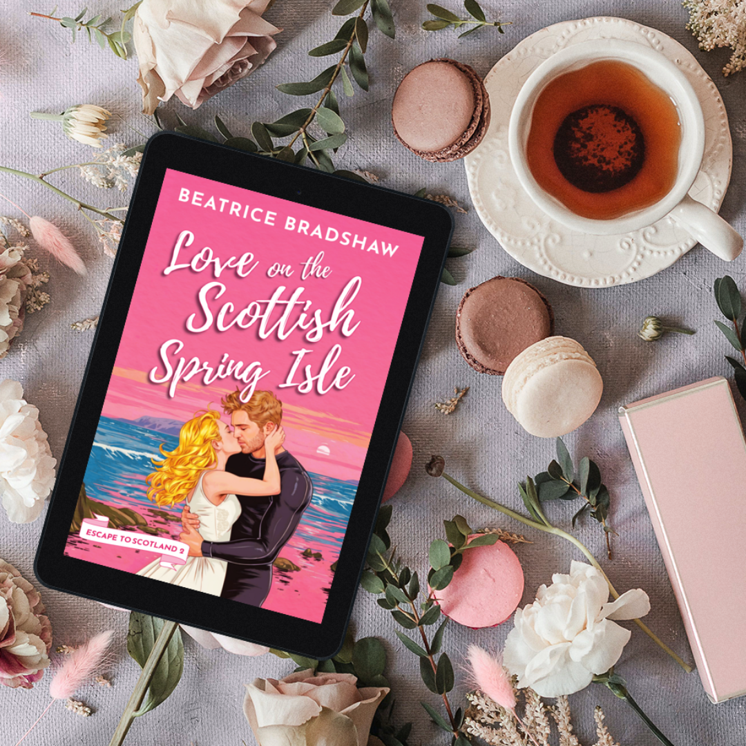 The cover of Love on the Scottish Spring Isle on a tablet surrounded by macarons, flowers, and a cup of tea