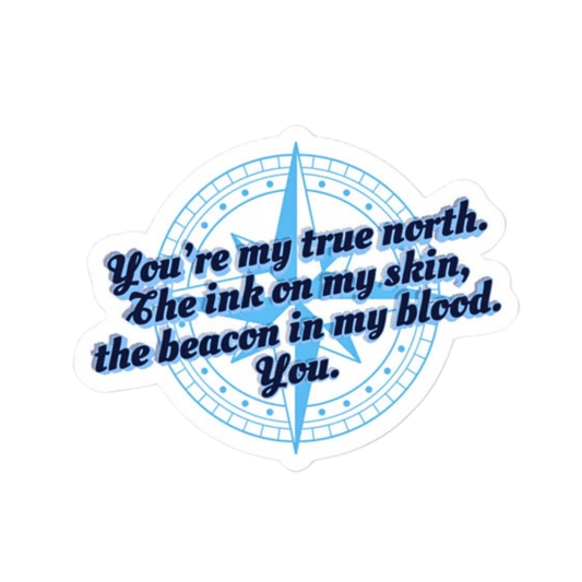 A die-cut sticker featuring a light blue compass design with the quote 'You're my true north. The ink on my skin, the beacon in my blood.